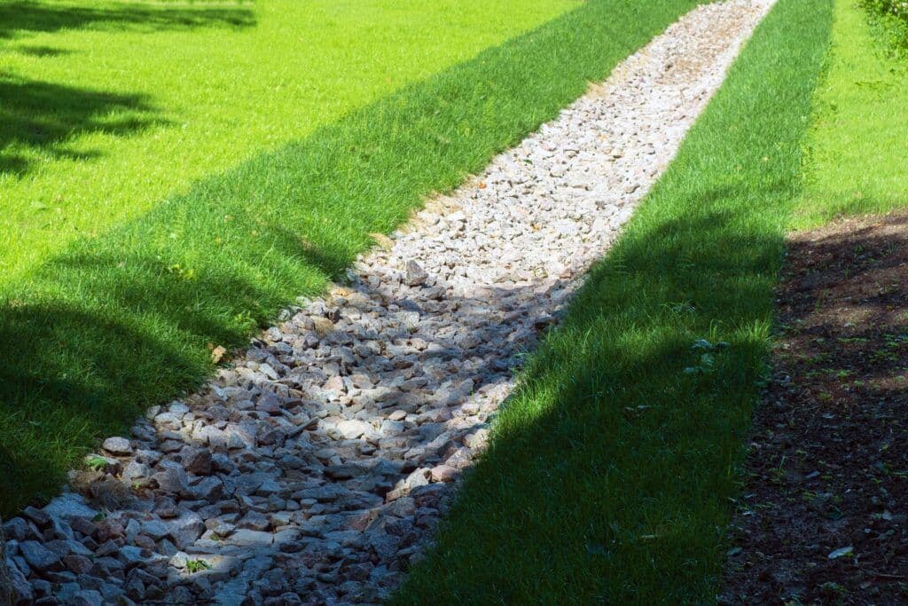 French drain trench dug alongside a Florida lawn