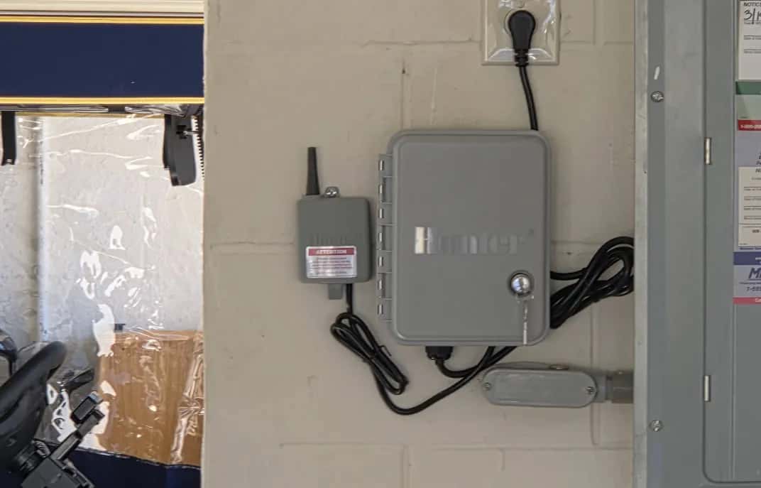 Hunter irrigation controller and wireless sensor receiver mounted on a garage wall