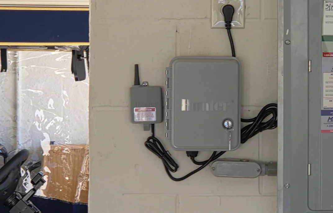 Hunter irrigation controller and wireless sensor receiver mounted on a garage wall