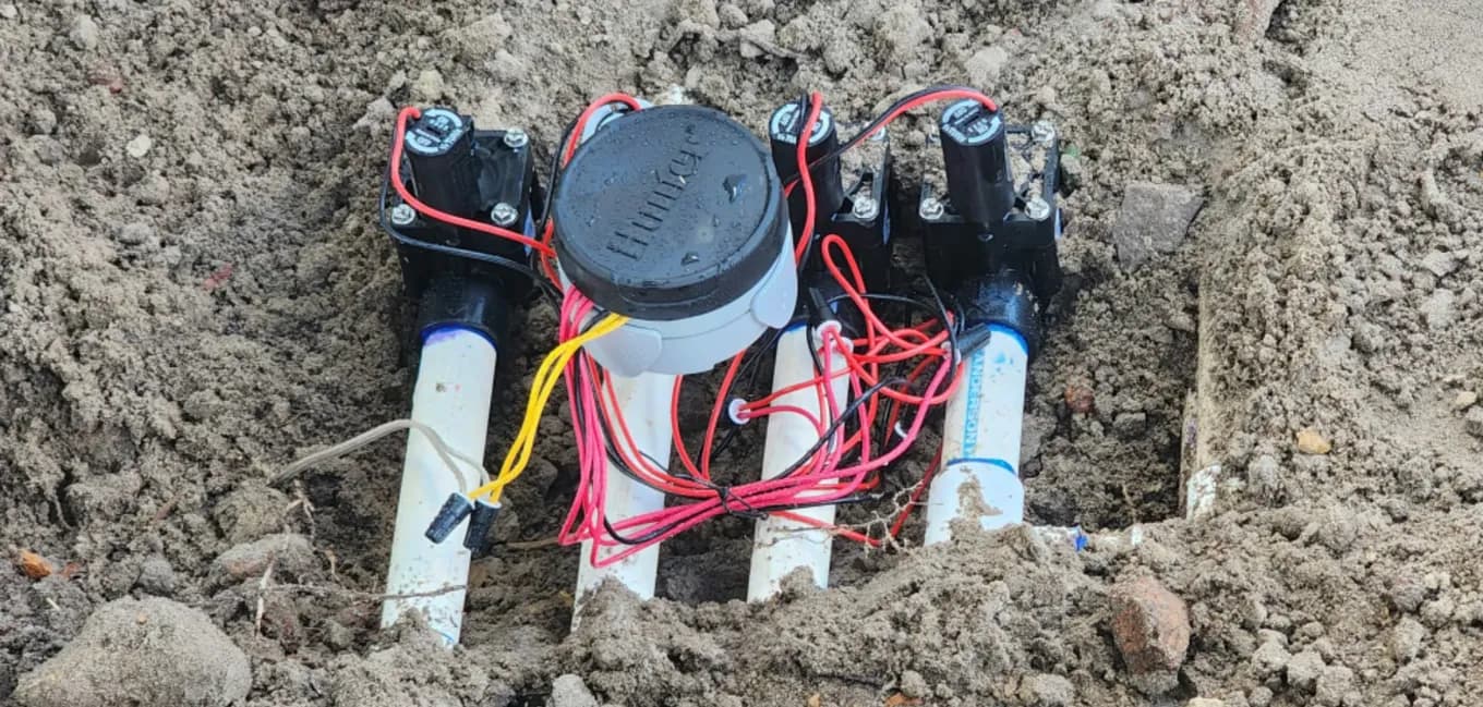 Four new sprinkler zone valves with fresh wiring and a Hunter battery-operated controller installed