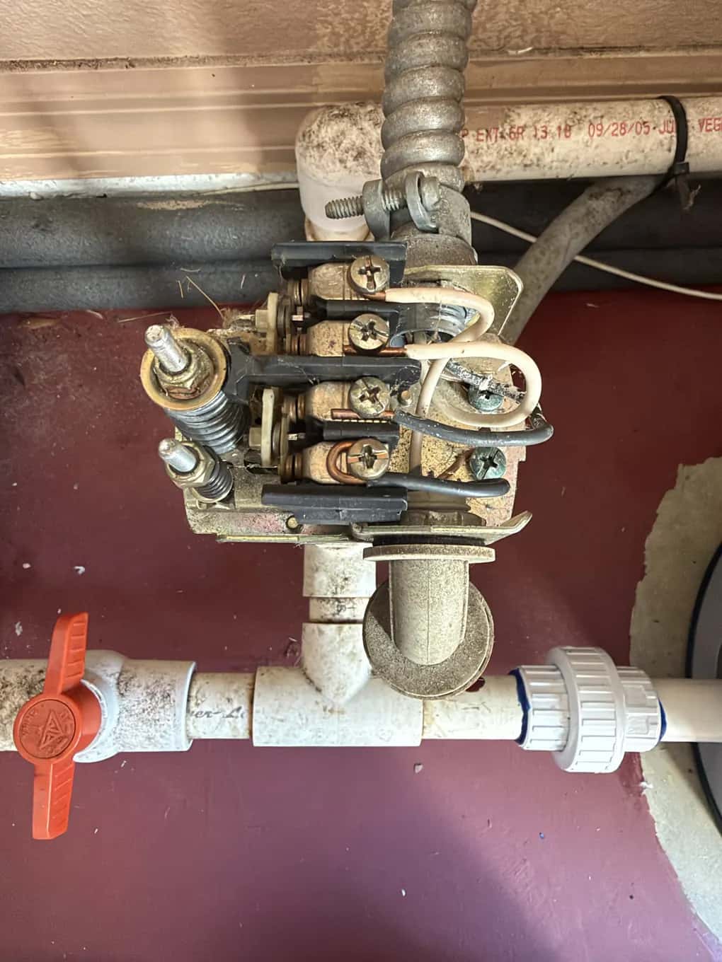 Close-up of a worn, corroded well pump pressure switch with its cover off