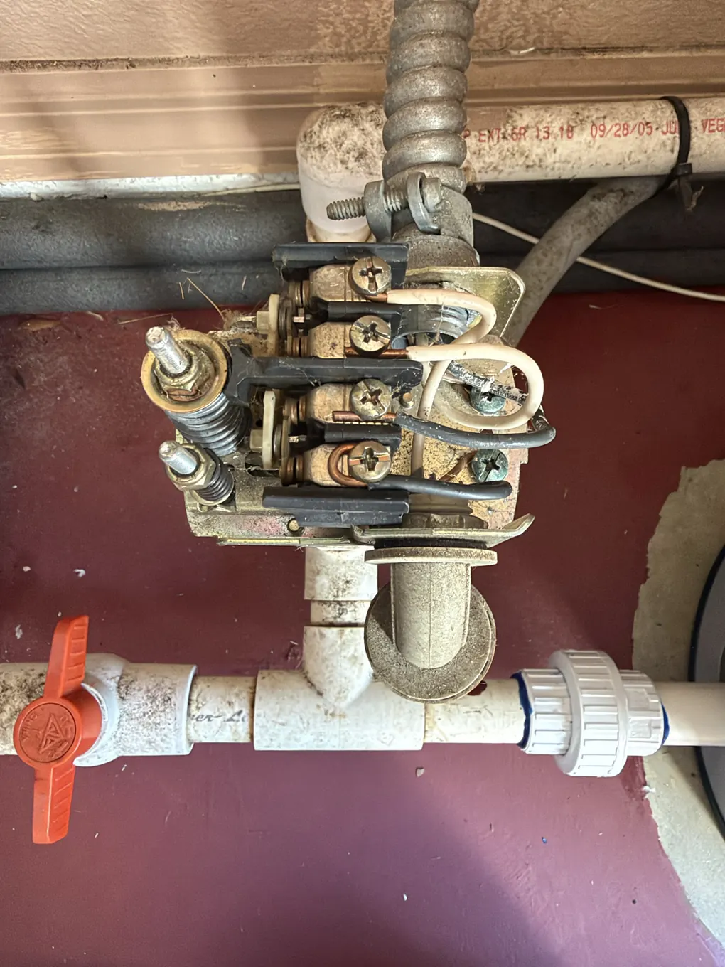 Close-up of a worn, corroded well pump pressure switch with its cover off